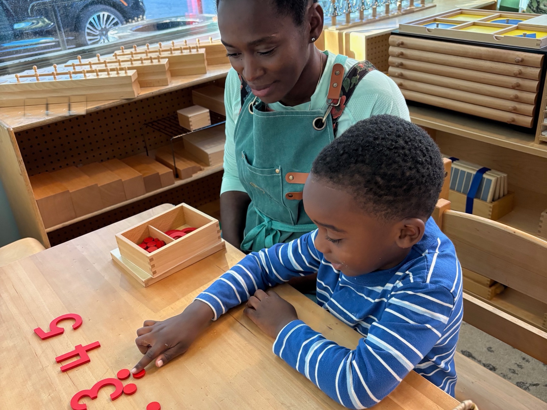 A guide presenting a lesson to one child
